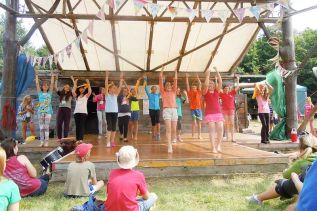 Band leader Teilhard Frost leads the Blue Skies Camp Choir at their Friday showcase in Clarendon)   